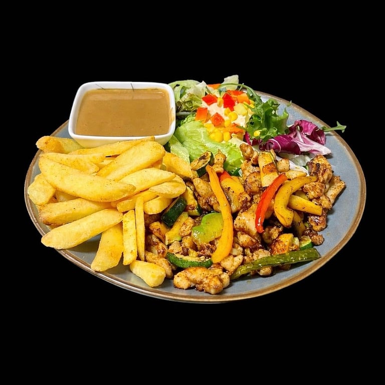 Plated meal with golden fries, seasoned meat strips, fresh salad, and sauce on black background